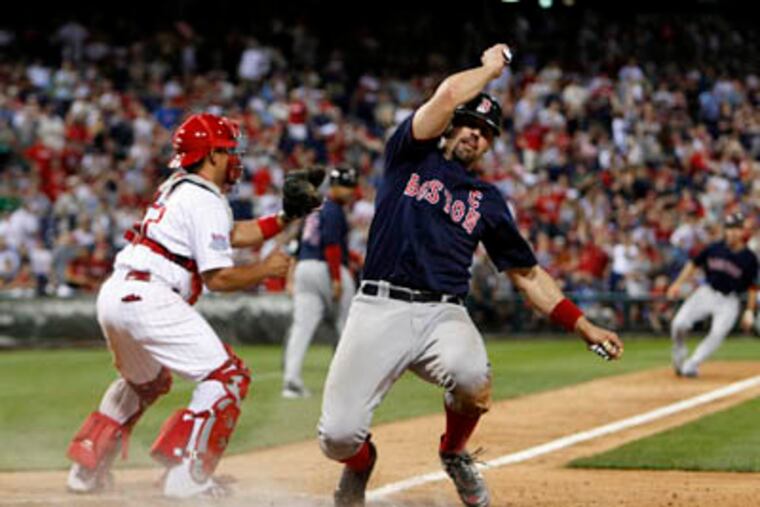 Jason Varitek easily scores Boston's third run in the 13th inning, their fifth of the game, after a hit by Mike Lowell. The Red Sox defeated the Phillies, 5-2, Friday. (Ron Cortes / Staff Photographer)