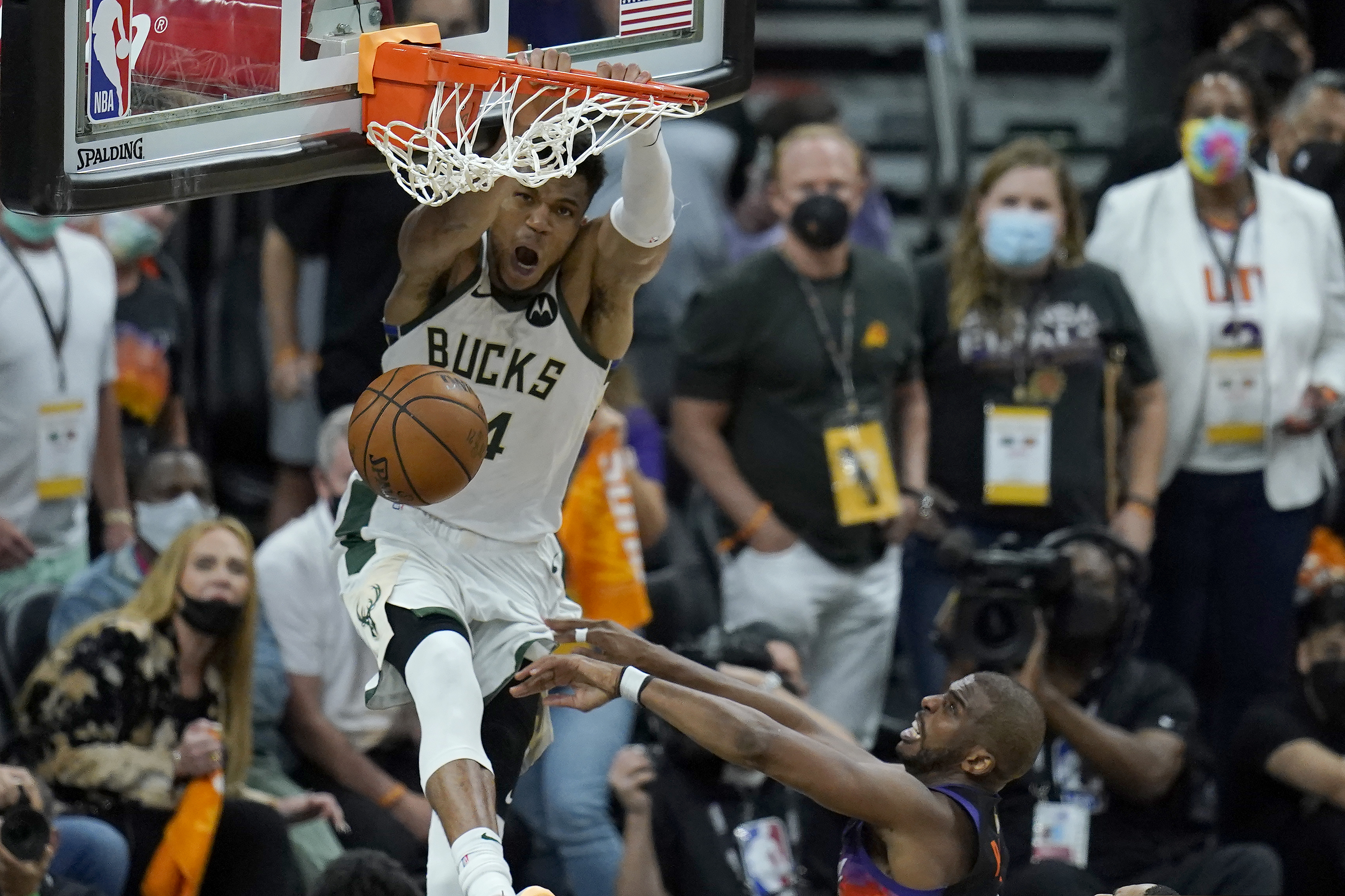 Milwaukee Bucks forward Giannis Antetokounmpo dunks over Phoenix Suns guard Chris Paul during the second half of Game 5.