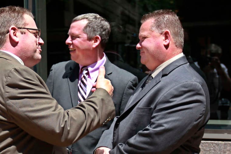 MICHAEL BRYANT / STAFF PHOTOGRAPHER After their acquittals in May (from left), Michael Spicer, Brian Reynolds and Perry Betts gather outside Federal Court.