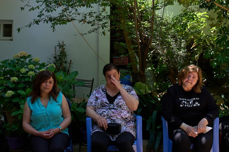 Lolitta Costantine (from left), Wadiaa Salloum, and Marie Salloum sit outside Costantine's home in the southern town of Jdeidat Marjayoun, Lebanon, on June 11.