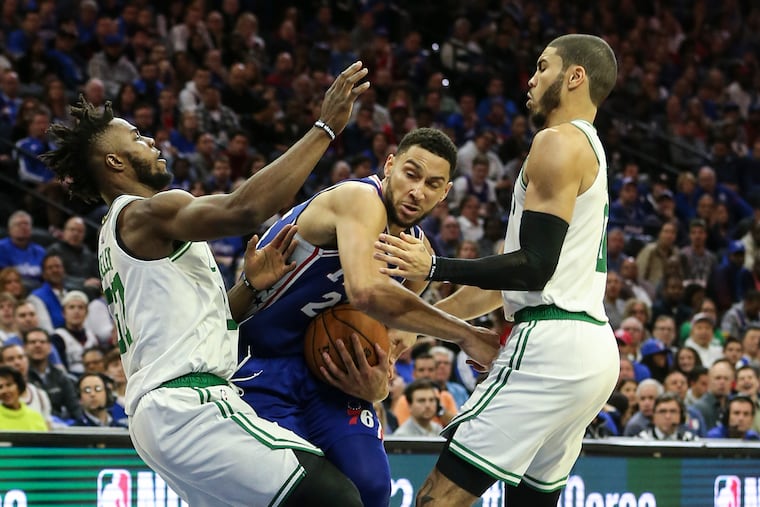 Sixers' Ben Simmons drives between Celtics' Semi Ojeleye (left) and Jayson Tatum on Wednesday night.