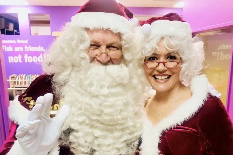Flyers legend Bernie Parent (left) and his wife, Gini. The Hall of Fame goalie will greet youngsters as Santa Claus.