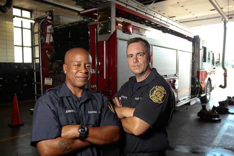 From Ladder 47, Philadelphia firefighters Alvin Jenkins, left, and Eric Siegfried, right, rescued a semiconscious worker who fell 60 feet in a petroleum tank last year, are among the public servants being honored at the National Liberty Museum's Awards of Valor ceremony. ( MICHAEL BRYANT / Staff Photographer )