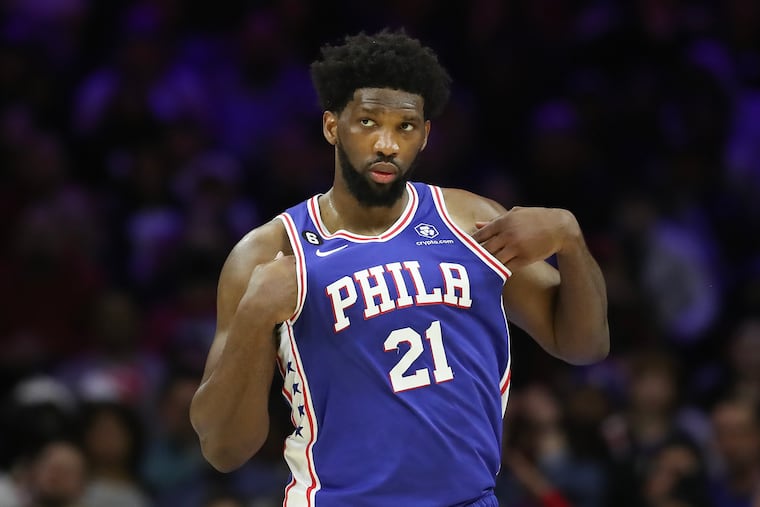 Sixers center Joel Embiid adjust his jersey against the Memphis Grizzlies on Thursday, February 23, 2023 in Philadelphia.