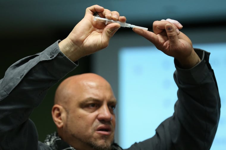 Elvis Rosado of Prevention Point Philadelphia shows families whose loved ones are addicted how to administer Narcan, a nasal spray version of the opioid overdose reversal medication naloxone, during a two-hour training on Wednesday, Dec. 13. The city Department of Behavioral Health plans more sessions in the new year.