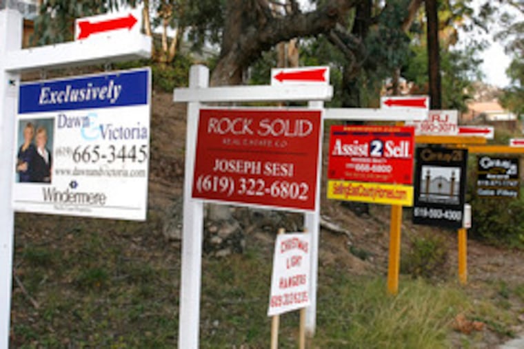Multiple signs advertise homes for sale in San Diego amidthe housing slump. In November, 647,000 new homes were reported sold nationwide, a 9 percent dip from October.