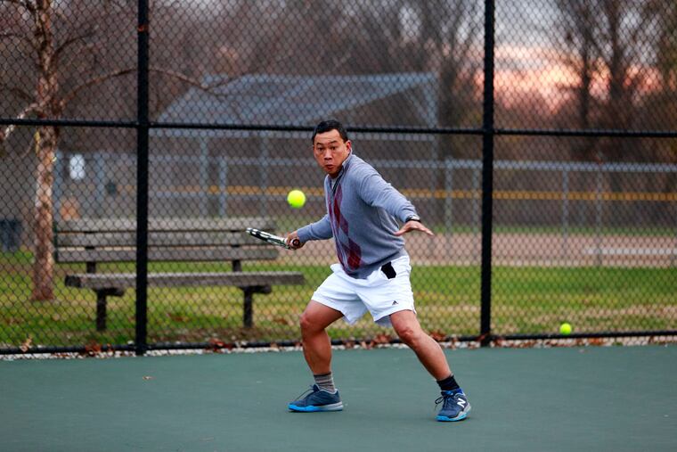 Shorts, anyone? Dang Nguyen, 53, of Philadelphia, took advantage of the mild weather to play tennis at FDR Park.