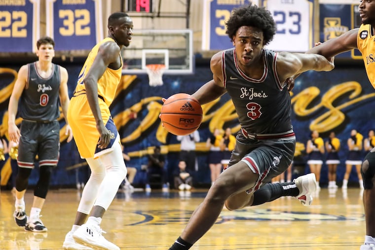 Saint Joseph's guard Cameron Brown, seen in action against La Salle, scored a game-high 25 points in a 74-68 Hawks win over Massachusetts on Saturday at Hagan Arena.