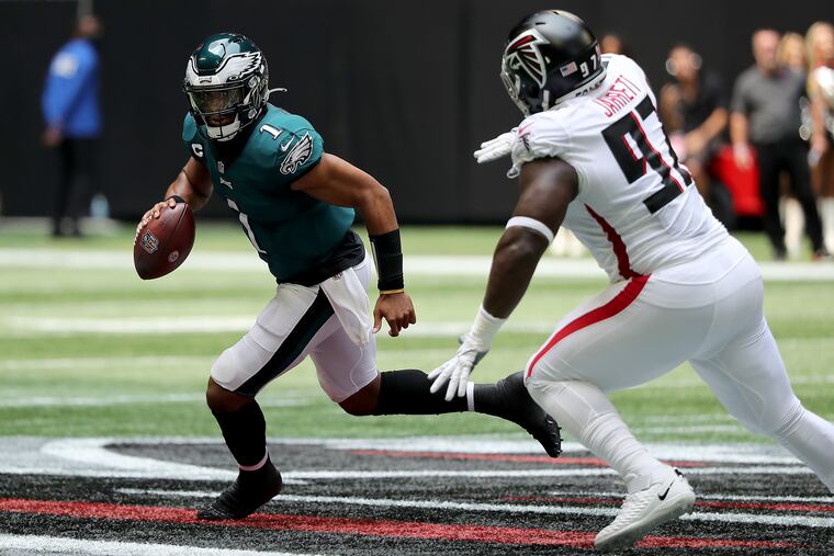 Philadelphia Eagles quarterback Jalen Hurts scrambles away from Atlanta Falcons defensive tackle Grady Jarrett in the second quarter. Hurts and the Eagles committed zero turnovers in the 32-6 blowout of Atlanta, the biggest reason the Eagles won.