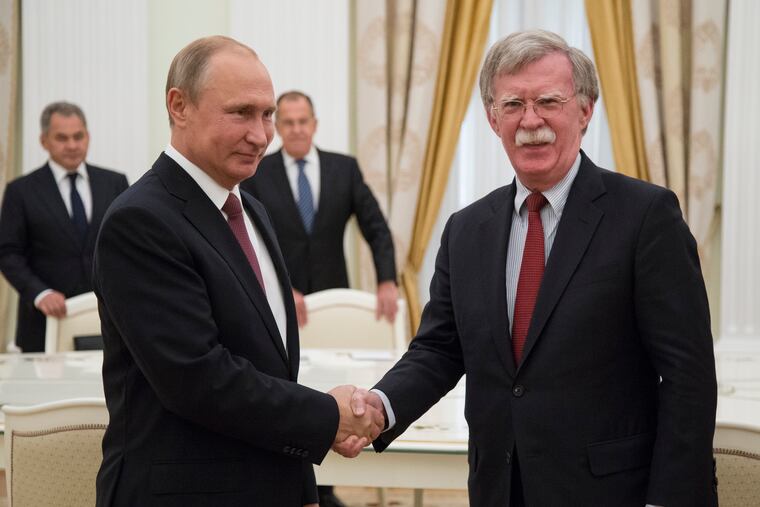 Russian President Vladimir Putin, left, shakes hands with U.S. National security adviser John Bolton during their meeting in the Kremlin in Moscow, Russia, Wednesday, June 27, 2018.