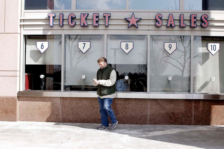 The Phillies announced Wednesday that they are offering refunds to any fans who purchased tickets for games that were to be played this season in April and May. Pictured is Mark Ackerman of Willow Grove leaving the ticket window at Citizens Bank Park in 2018 with his Phillies tickets.