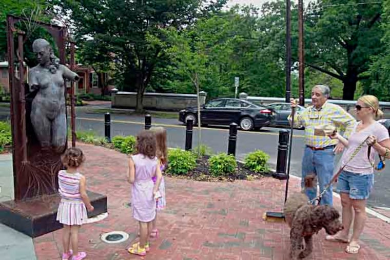 The controversial nude statue "Uno" will be dedicated Saturday morning at Mechanic and Clement streets, in the heart of historic, downtown Haddonfield.
Kristen Poliafico ( right with Dog) is chatting with Stuart Harting , Chairman of Haddonfield Outdoor Sculpture Trust while Nina Poliafico,3 (left) Claudia Fisicaro,6 (2nd from left) Ava Poliafico ,6 are watching the sculpture before the dedication ceremony.
June 8, 2013( AKIRA SUWA / Staff Photographer )
