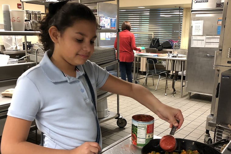 Genesis Vila-Diaz learns to make shakshouka during week three of the spring 2019 My Daughter's Kitchen cooking program at Hunter.