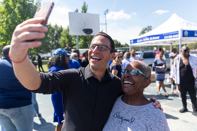 Attorney General Josh Shapiro, the Democratic nominee for Pennsylvania governor, taking a video with Muriel Taylor, of North Philadelphia, at Mander Playground in Philadelphia on Saturday. Shapiro's campaign is trying a variety of tactics to mobilize Black voters ahead of the November election.
