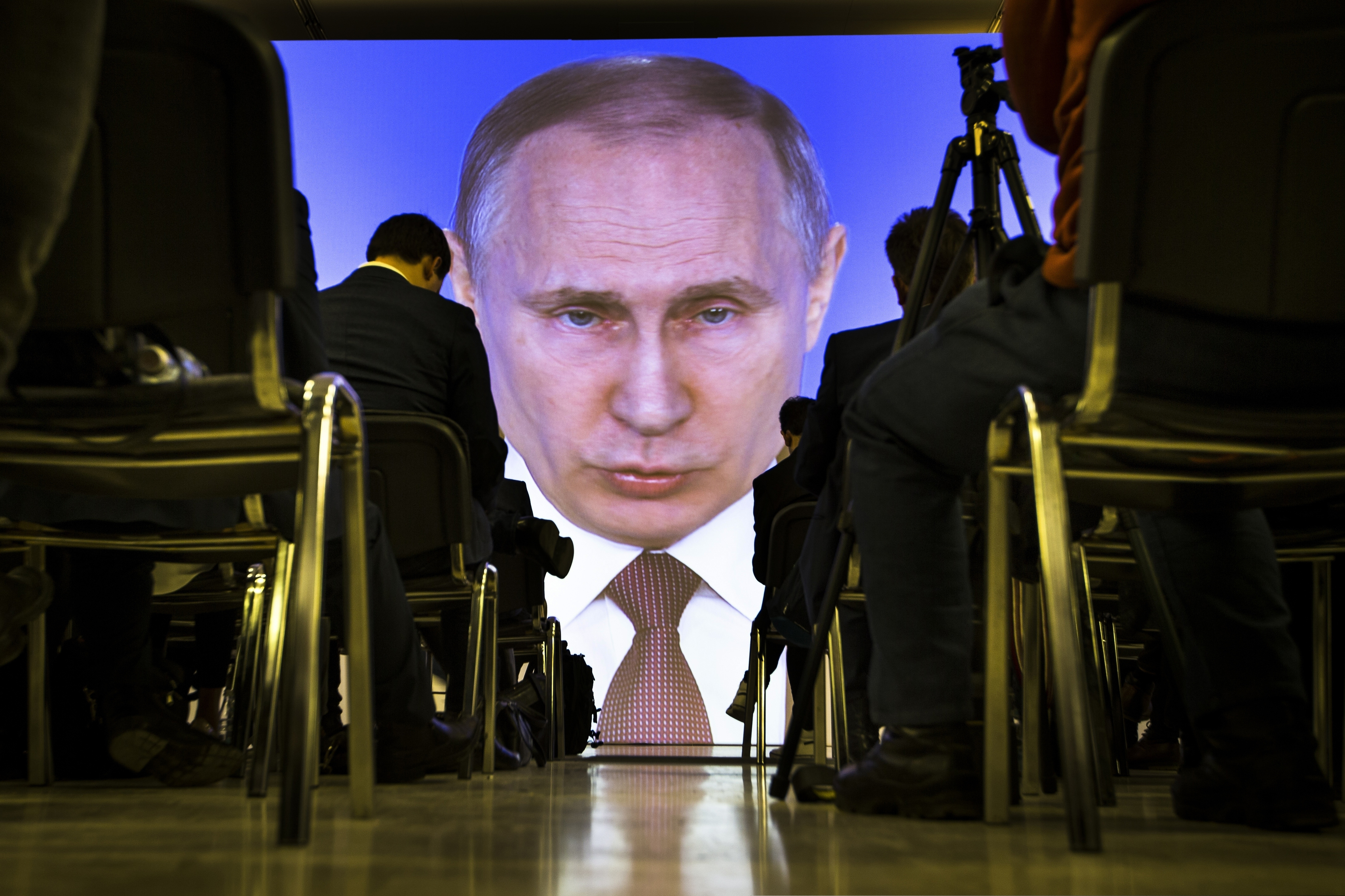 Journalists watch as Russian President Vladimir Putin gives his annual state of the nation address in Manezh in Moscow, Russia, on March 1, 2018. (AP Photo/Alexander Zemlianichenko)