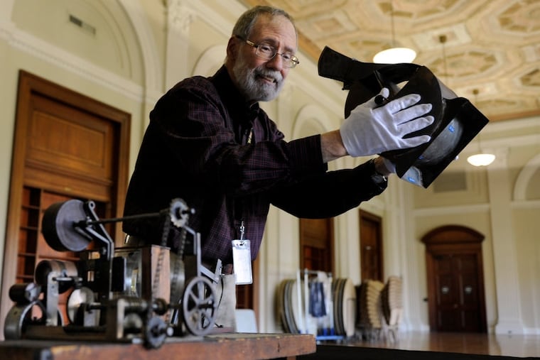 Mr. Alviti, shown here with an old Kinematoscope, was adept at merging his collections with educational programs.