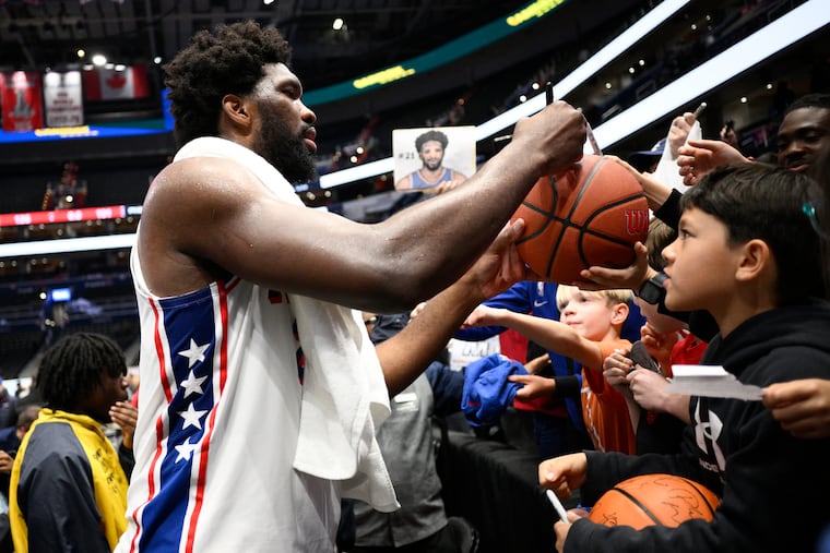 Sixers center Joel Embiid signed autographs after his 50-point performance against the Washington Wizards.