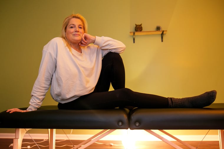 Regan Tilton poses for a portrait before a recent reiki treatment with practitioner Alexandra Kurowski in Center City. Reiki is among the tools Tilton uses to help manage pre-holiday stress.