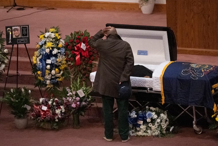 An unidentified person pays his respects on Friday, December 16, 2022, during the funeral of former state senator T. Milton Street at the Deliverance Evangelistic Church in Philadelphia, Pa.