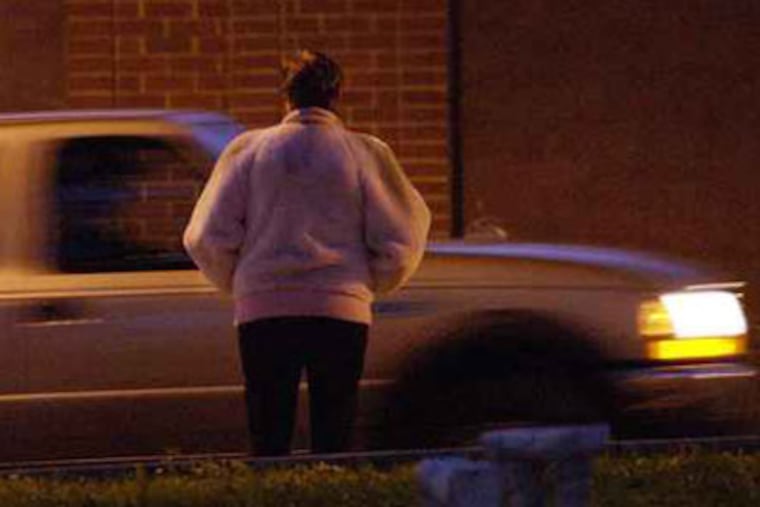 File photo of Kensington Avenue shows an an undercover female officer posing as a prostitute.