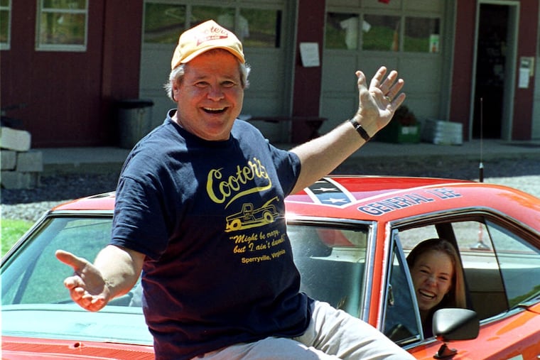 Cooter, played by actor Ben Jones, sits atop the General Lee, used in the show "Dukes of Hazzard."