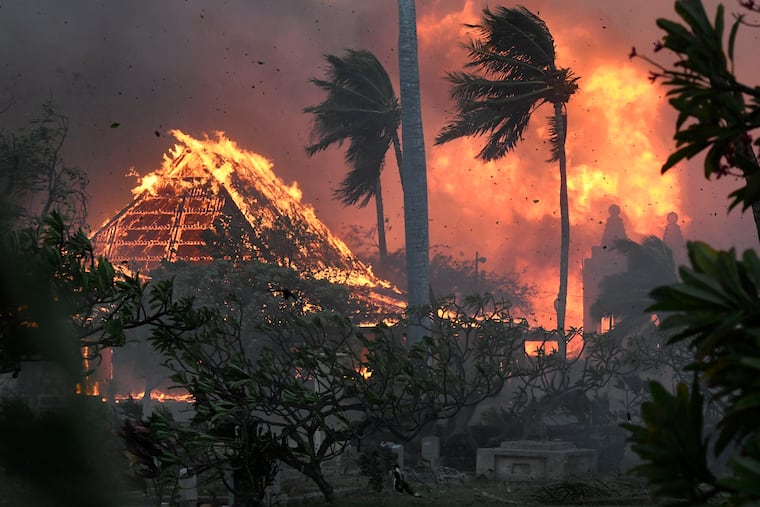 The hall of historic Waiola Church in Lahaina and nearby Lahaina Hongwanji Mission are engulfed in flames along Wainee Street on Tuesday in Lahaina, Hawaii.