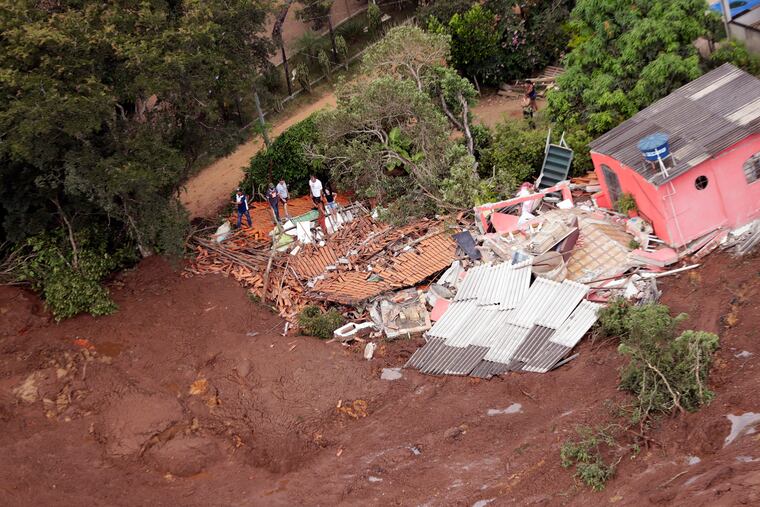 An aerial view shows a destroyed house after a dam collapsed in Brumadinho, Brazil, Saturday, Jan. 26, 2019. Rescuers searched for survivors in a huge area in southeastern Brazil buried by mud from the collapse of dam holding back mine waste, with several people dead and hundreds missing. (AP Photo/Andre Penner)