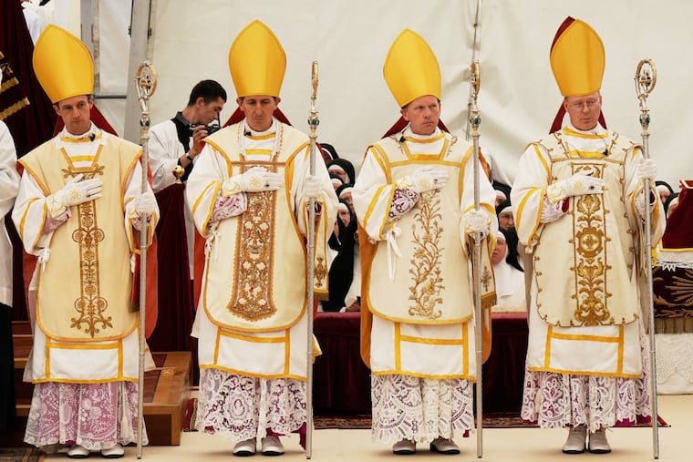 Newly consecrated Bishops, from left, Marc Hanappier, Michel Poinsinet de Sivry, Michael Goldade and Pascal Schreiber wearing their miters and holding their pastoral staffs, stand at the end of their consecration ceremony in a tent set up outside the Society of St. Pius X seminary in Econe, Switzerland, Wednesday, July 1, 2026.