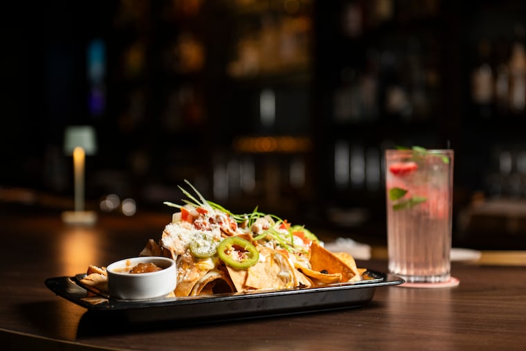 Nachos with a strawberry basil smash cocktail at 333 Belrose.