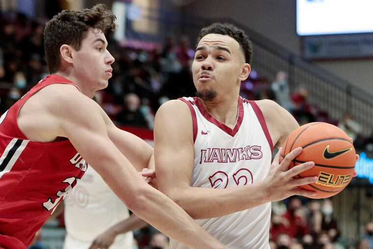 Jordan Hall of St. Joseph's going by Davidson defense.