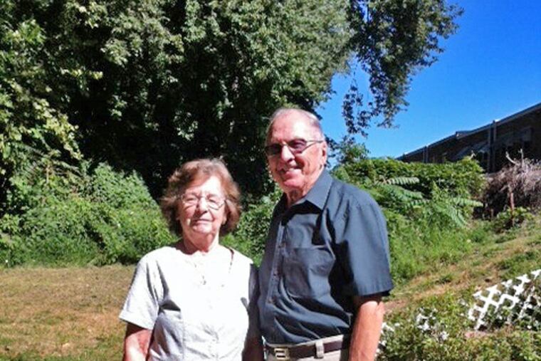 Joe and Janet Witkowski with some of the Fairmount Park trees that abut their backyard in Northeast Philly.