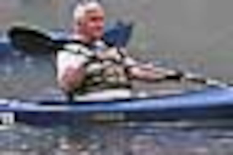 Pennsylvania Govenor Tom Corbett, left, paddles along the Delaware River in his kayak along with a group of state environmental and conservation employees. Paddling along w/Gov Corbett on his latest kayak trek -- 10 miles circa Delaware Water Gap, starting Fri 730am. Anti-fracking protests expected.( MICHAEL BRYANT / Staff Photographer )