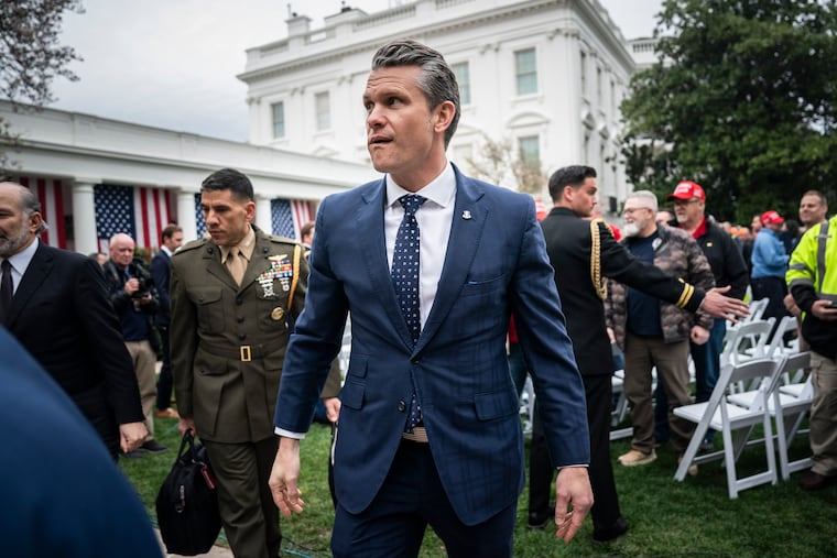 Defense Secretary Pete Hegseth is trailed by his military aide, now senior adviser, Ricky Buria at a White House event in April.