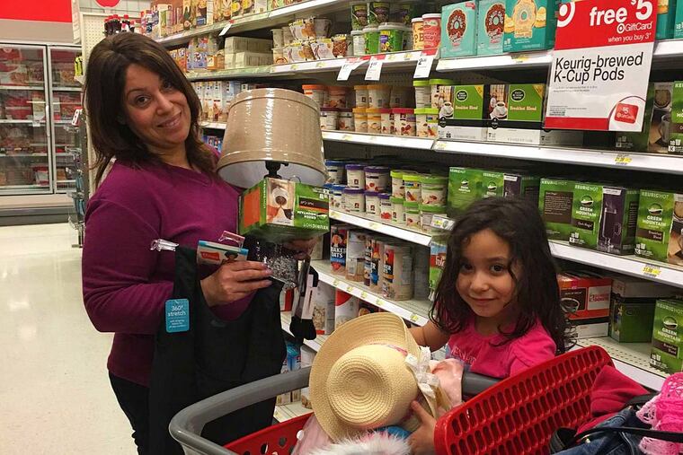 Olga Harris, with granddaughter Leanah Soto, 4, shops at a Target store in Langhorne. Having all of the items she wants under one roof "saves me gas and time," she said. "I love it."