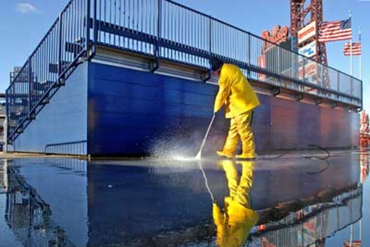 Leonard Bowen washes the concourse behind the outfield bleachers in Ashburn Alley at Citizens Bank Park on Wednesday in preparation for Saturday's Game 3 of the World Series. (Tom Gralish / Staff Photographer)
