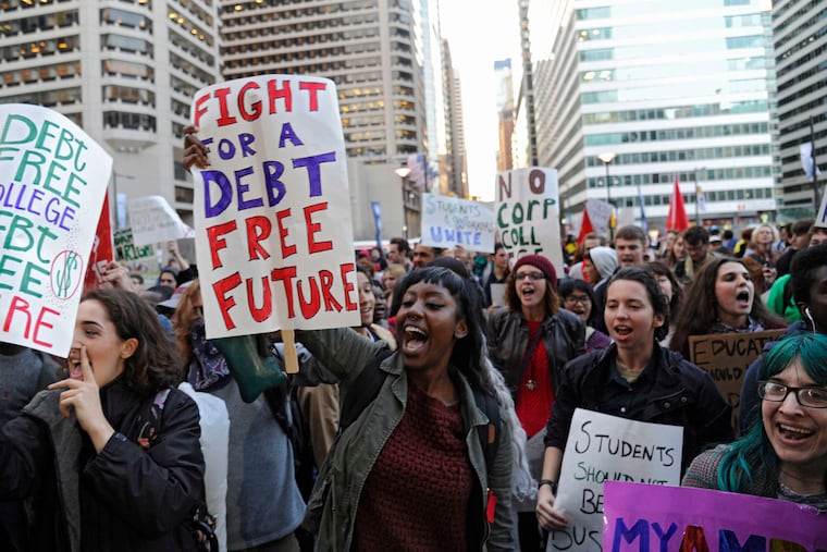 Another theme in the march to City Hall was the heavy burden of student loans, as expressed on these signs.