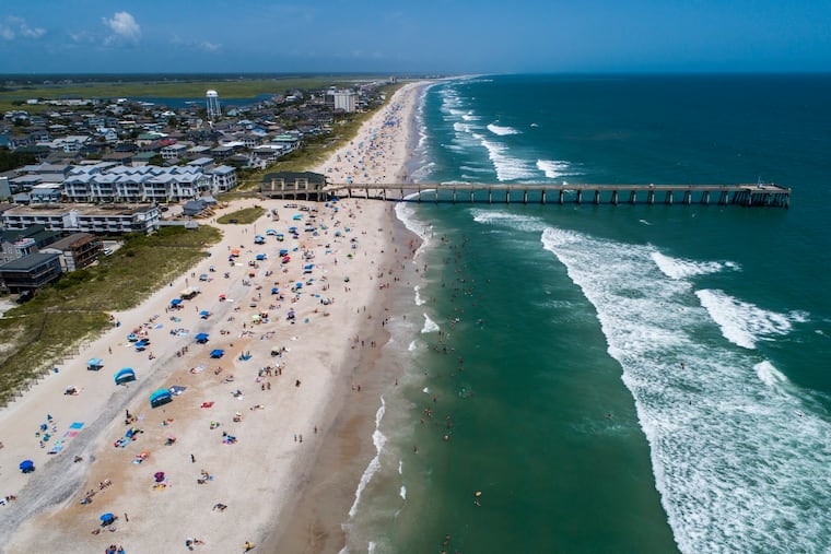 Beachgoers packed Wrightsville Beach, N.C., on Sunday as Tropical Storm Isaias moved along the Southeast Coast.