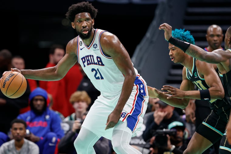 Sixers center Joel Embiid (21) looks to pass the ball as Hornets forward Kai Jones defends during the first half.