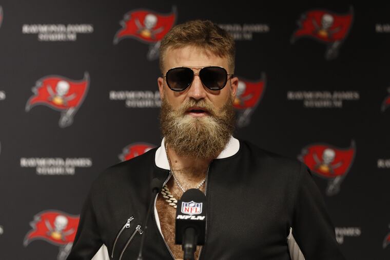 Tampa Bay quarterback Ryan Fitzpatrick plays dress-up after beating Eagles.