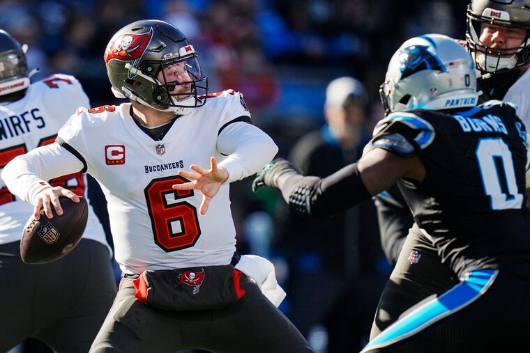 Tampa Bay Buccaneers quarterback Baker Mayfield works in the pocket as Carolina Panthers linebacker Brian Burns defends during the first half,