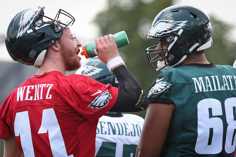 Eagles quarterback Carson Wentz (left) with Jordan Mailata on the opening day of training camp.