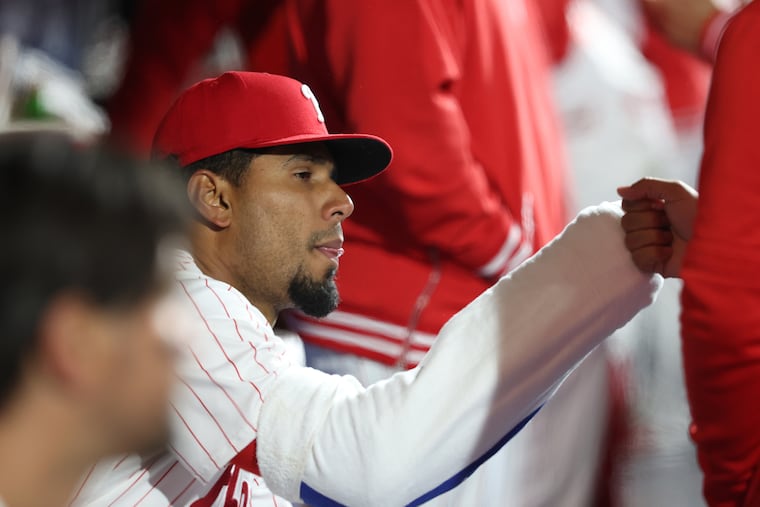 Phillies reliever Ricardo Pinto is congratulated between innings of the 9-4 victory over the Reds on Tuesday.