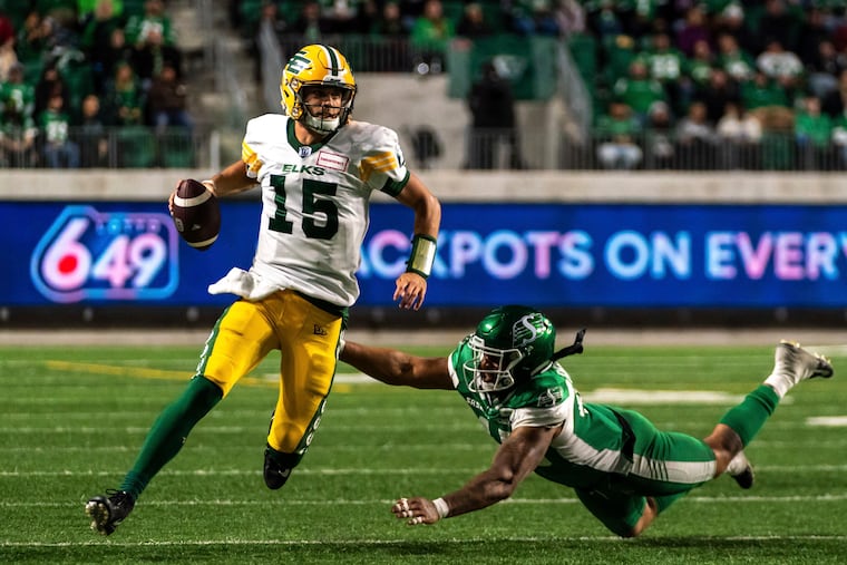 Edmonton Elks quarterback Taylor Cornelius evades a tackle from Saskatchewan Roughriders defensive lineman Pete Robertson during a Canadian Football League game on Sept. 16, 2022.