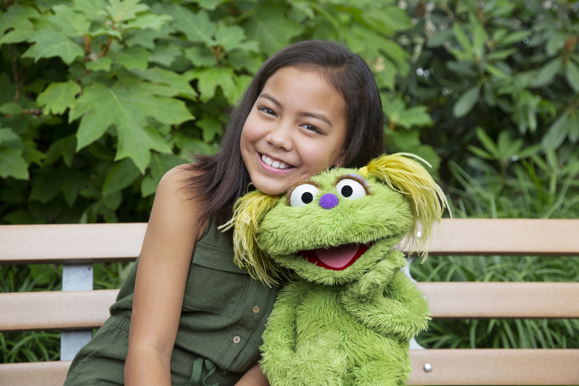 This undated image released by Sesame Workshop shows 10-year-old Salia Woodbury, whose parents are in recovery, with "Sesame Street" character Karli. Sesame Workshop is addressing the issue of addiction. Data shows 5.7 million children under 11 live in households with a parent with substance use disorder. Karli had already been introduced as a puppet in foster care earlier this year but viewers now will understand why her mother had to go away for a while.