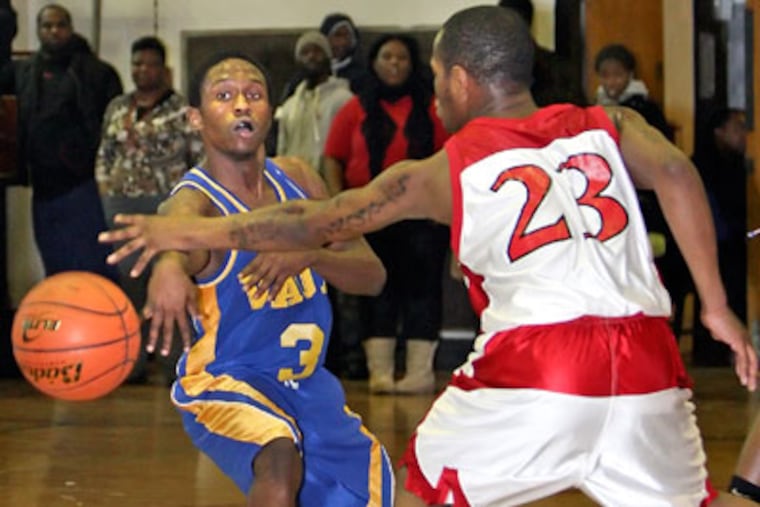 Vaux's Jaleel Williams throws a pass around Strawberry Mansion's
Khalil Whitehead. (Steven M. Falk/Staff Photographer)