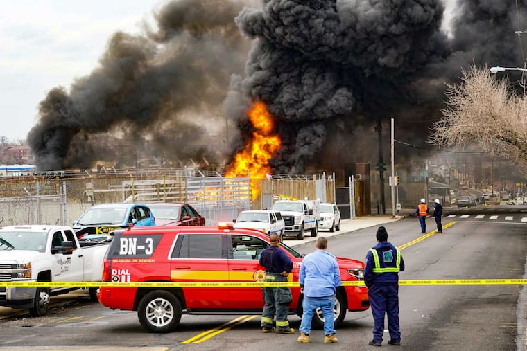 Emergency crews watch a fire burns inside a PECO substation on Fox Street near Westmoreland Street in the Nicetown section of Philadelphia on Tuesday March 7, 2017.