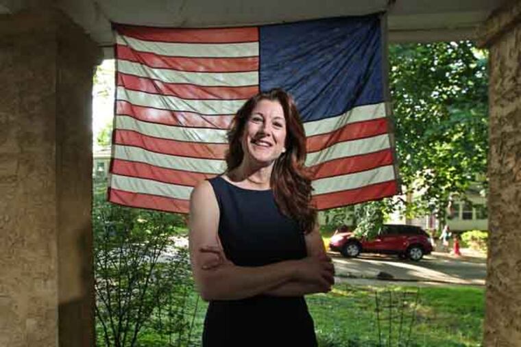 Denise Logsdon on the front porch of her Springfield home. Her family is in the Navy, her husband's Army so they fly the flag enthusiastically. Denise Logsdon, 45, of Springfield, who will walk in DCCC's graduation on the 23rd despite having had a major operation in April for cancer of her thyroid which left her vocal chords damaged and her right ear and portions of her scalp, neck, jaw and collarbone paralyzed. A mother of four children, Logsdon will receive an Associate of Science degree. She plans to transfer to the University of Pennsylvania, where she will study Human Rights and Social Justice. She hopes to one day pursue her Doctorate degree in Justice, Law and Policy and become a human rights advocate and policy scholar. She was also pres. of student government and the schools honor society. 05/20/2013