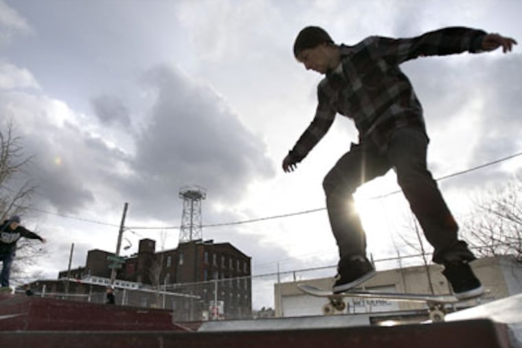 Jesse Clayton skates at the skateboard park he designed and built with
help from other skaters at Pop's Playground in Kensington. (David
Maialetti / staff photographer )