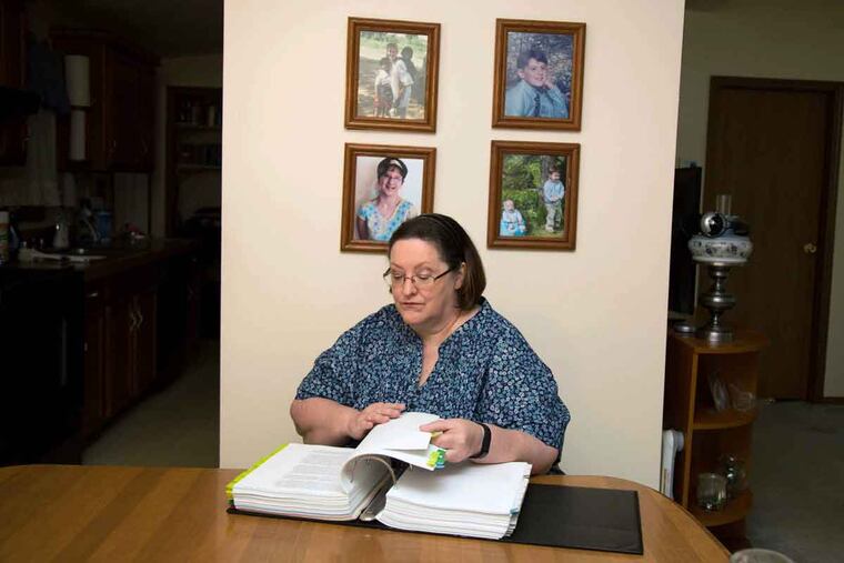 Gladys Stefany, whose daughter was enrolled at Agora Cyber Charter School, reviews some of her legal binders on the defamation suit that lasted nearly eight years.