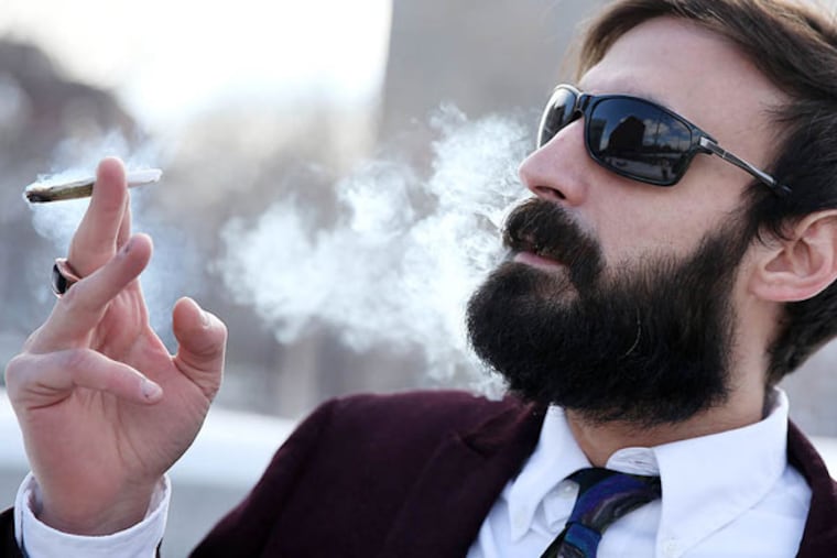 Pot activist N.A. Poe tokes it up on Independence Mall. (DAVID MAIALETTI / STAFF PHOTOGRAPHER)